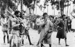 ethiopian_men_gather_in_addis_ababa_heavily_armed_with_captured_italian_weapons_to_hear_the_proclamation_announcing_the_return_to_the_capital_of_the_emperor_haile_selassie_in_may_1941-_k325